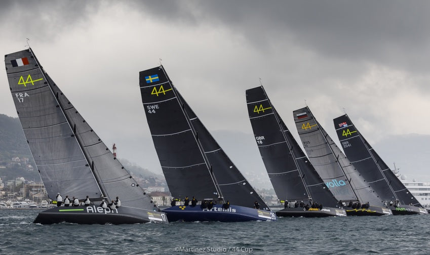 Precision racing in the 44Cup series, showcasing elite-level hydrofoil-inspired monohull sailing in dramatic coastal weather.